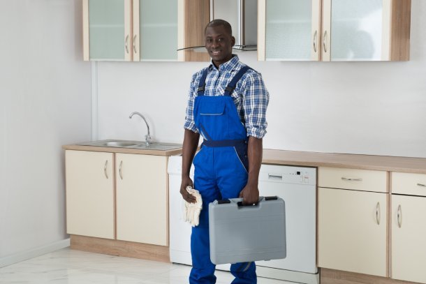 Technician standing in home kitchen